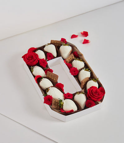 Luxury chocolate-covered strawberries and roses arranged in white hexagonal gift box forming letter G for birthday