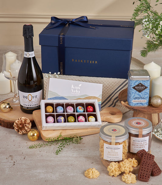 Navy luxury gift set with sparkling beverage, artisan chocolates, premium cookies, and festive gold accents for New Year