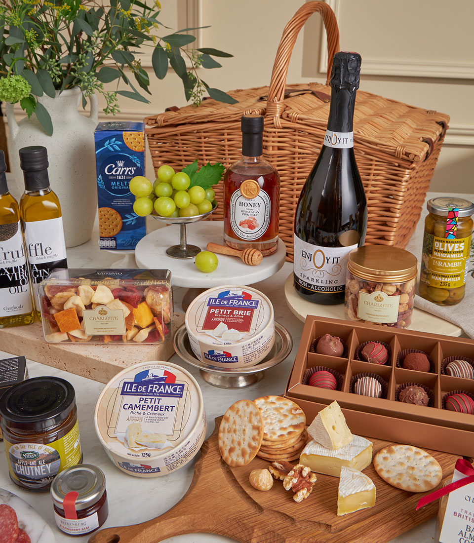 Basketeer's luxury gift basket: Brie, Camembert, crackers, chocolates, and sparkling juice in a wicker hamper. Perfect premium hamper delivery in Thailand.
