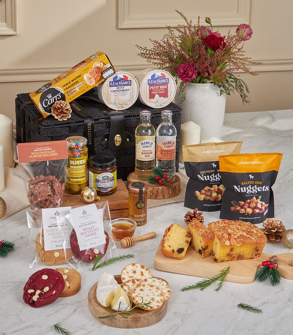 Luxury black woven gourmet cheese and snack hamper with artisan crackers, brie, camembert, chocolates, and gourmet beverages