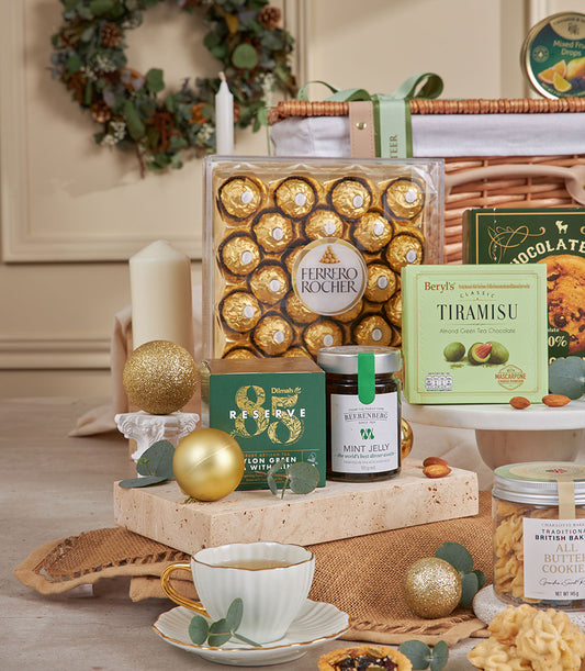 Luxury green celebration gift basket with Ferrero Rocher, gourmet tea, and artisan treats for New Year
