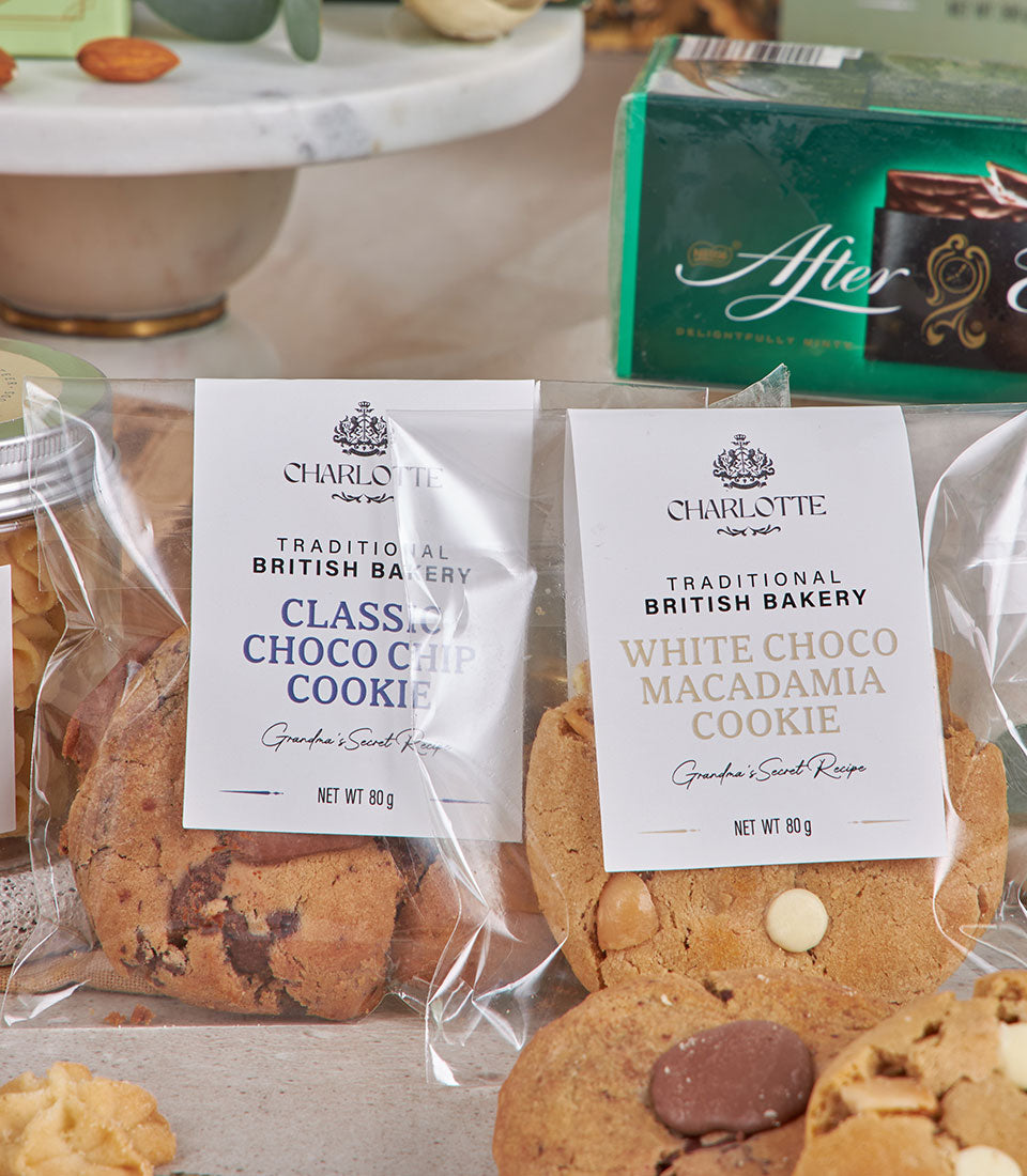 Green luxury gift basket with artisan cookies, After Eight mints, and gourmet treats for New Year celebrations