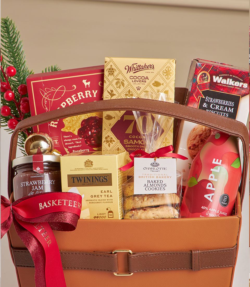 Premium leather hamper with raspberry cookies, chocolate, tea, and gourmet treats for New Year gifting