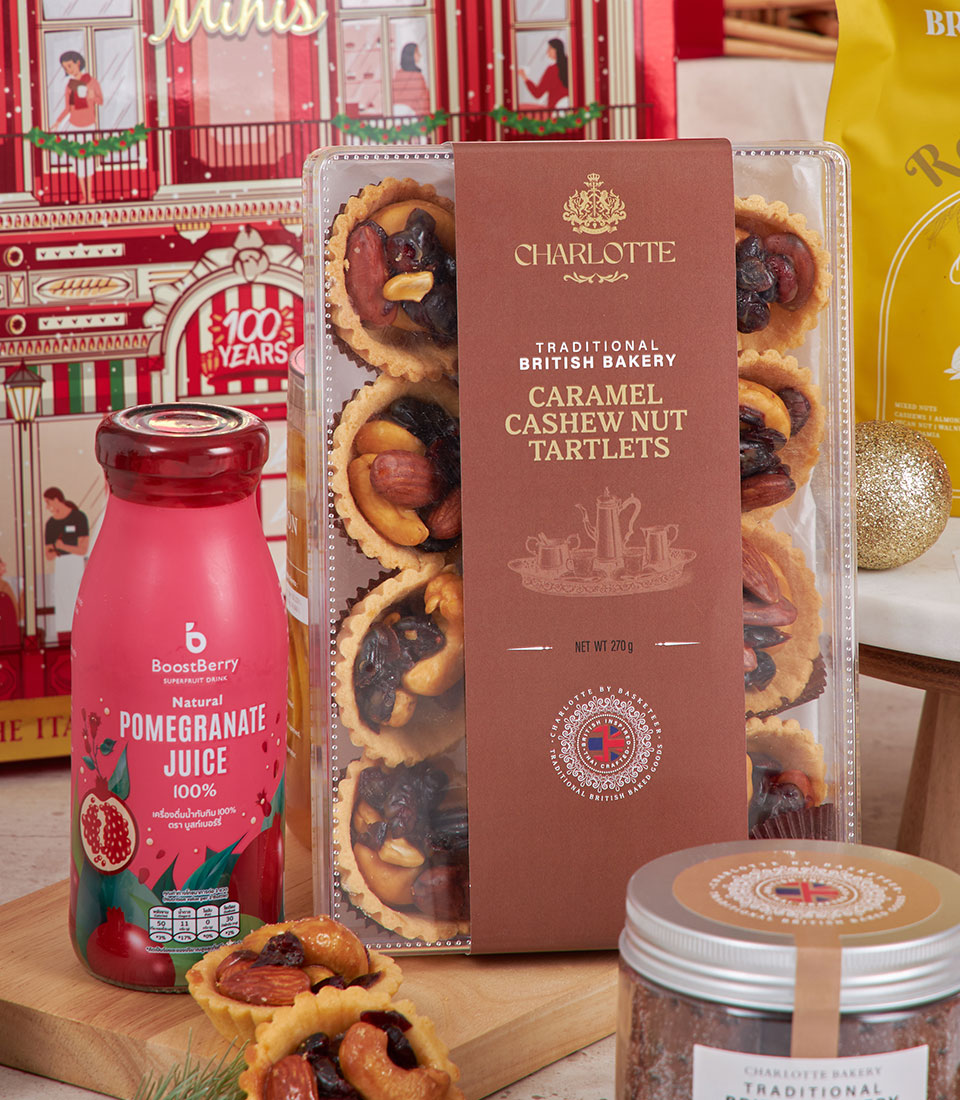 Sparkling New Year luxury hamper with caramel cashew tartlets, pomegranate juice, gourmet nuts, and festive gold accents