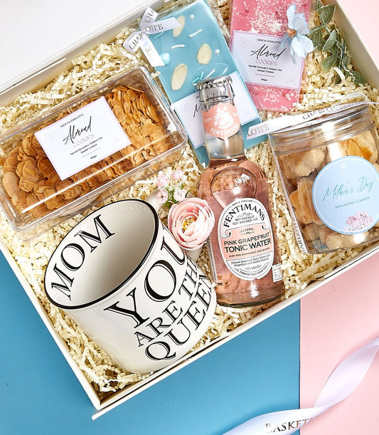 Luxury Mother's Day gift set with almond cookies, chocolates, grapefruit tonic, and ceramic queen mug