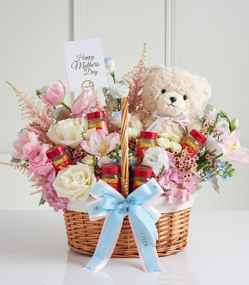 Cream teddy bear with fresh pink and white roses in wicker basket, Mother's Day gift