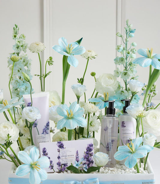 Luxury lavender spa basket with bath products and fresh blue and white flowers for Mother's Day