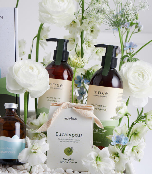 White Bloom Wellness gift basket with organic lemongrass and eucalyptus spa products nestled in fresh white flowers