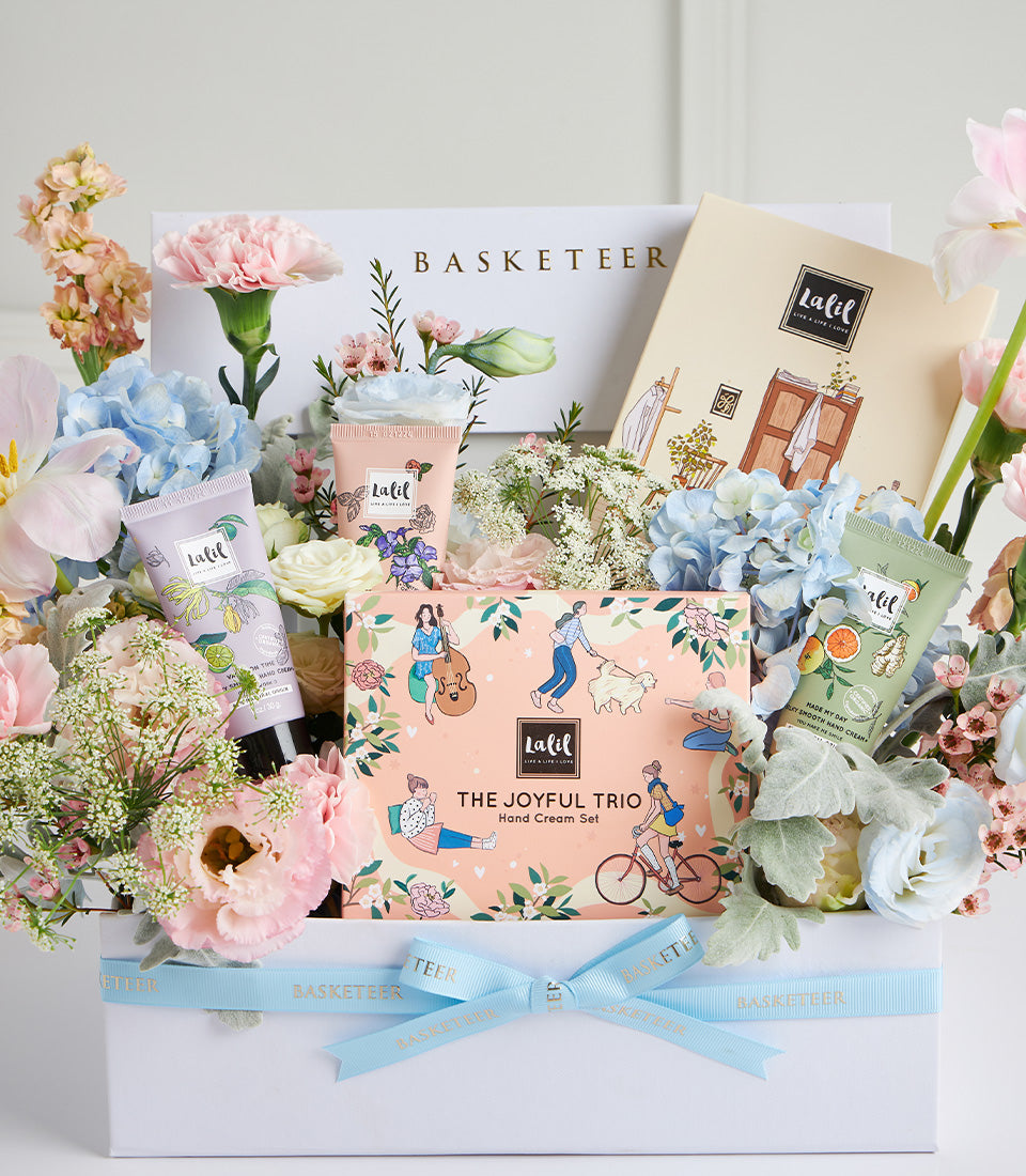 Peach hand cream gift set with fresh pink and blue flowers, luxury Mother's Day hamper from Basketeer