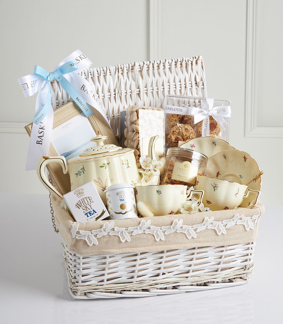 Luxury cream ceramic tea set with floral pattern and gold trim, White Sky Tea, Charlotte bakery treats, woven wicker basket