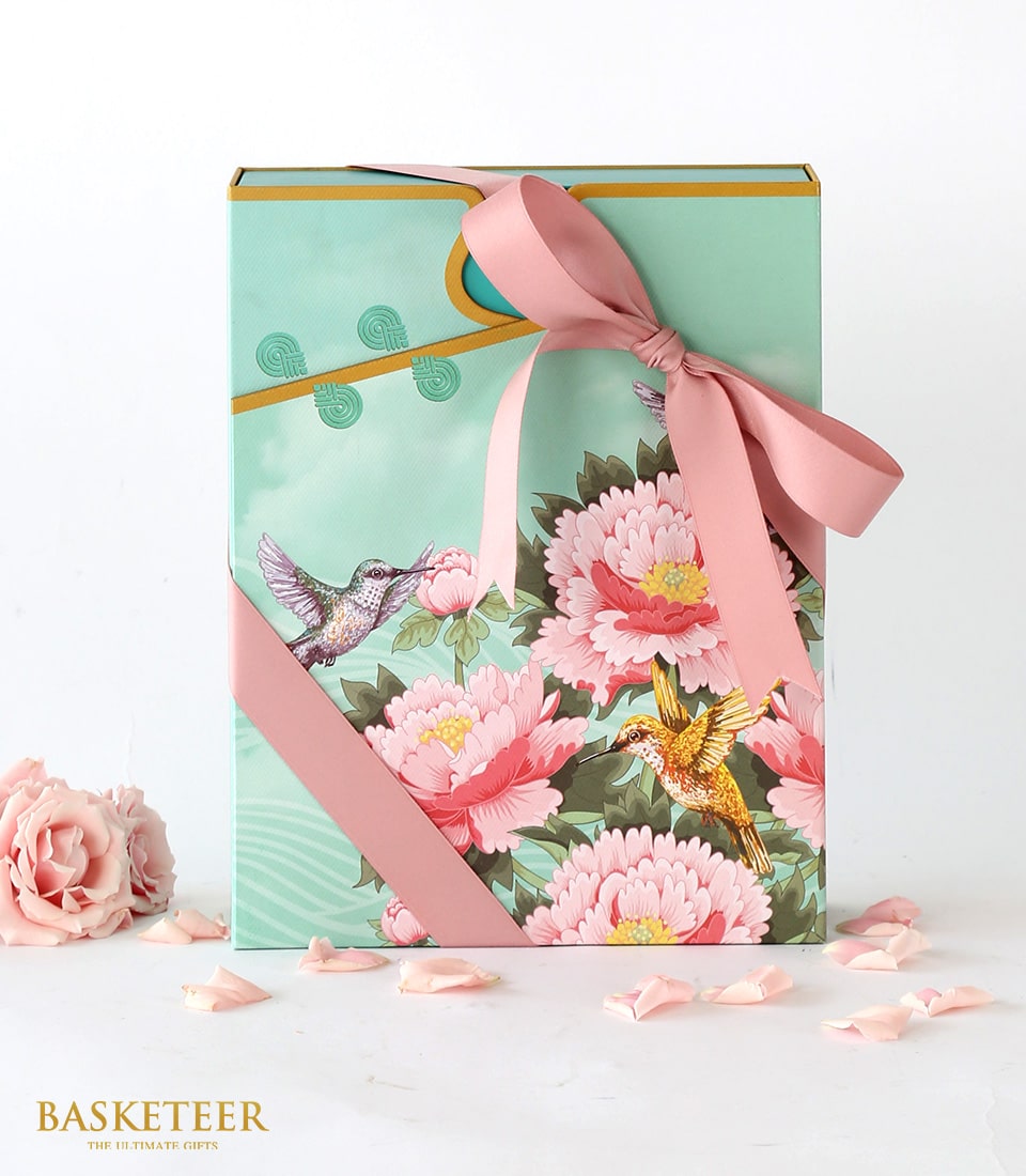 Mint green mooncake gift box with peony and hummingbird design, pink ribbon bow, and rose accents