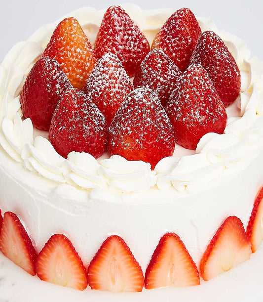Strawberry Vanilla Chiffon cake with fresh strawberries, whipped cream frosting, and powdered sugar