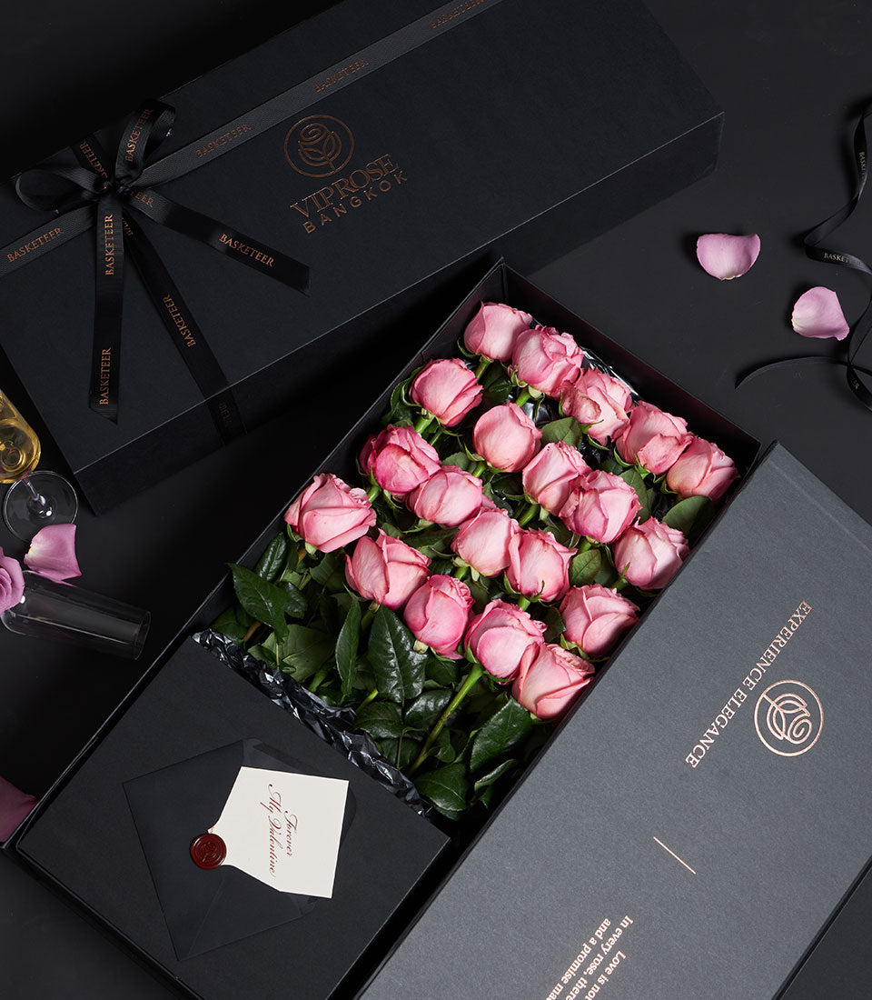 Luxury pink rose Valentine gift box with two dozen fresh blooms, black packaging, and romantic card