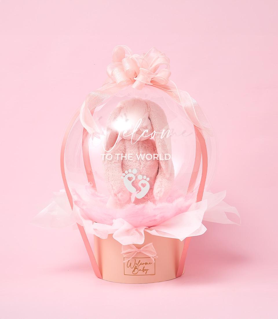 Pink hot air balloon baby gift with plush bunny, newborn welcome hamper by Basketeer