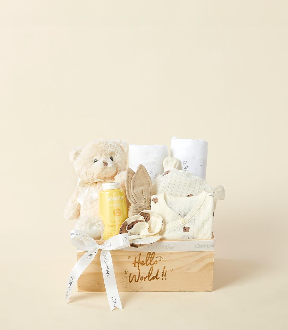 Wooden newborn gift box with cream teddy bear, organic baby powder, and matching bear-print clothing set