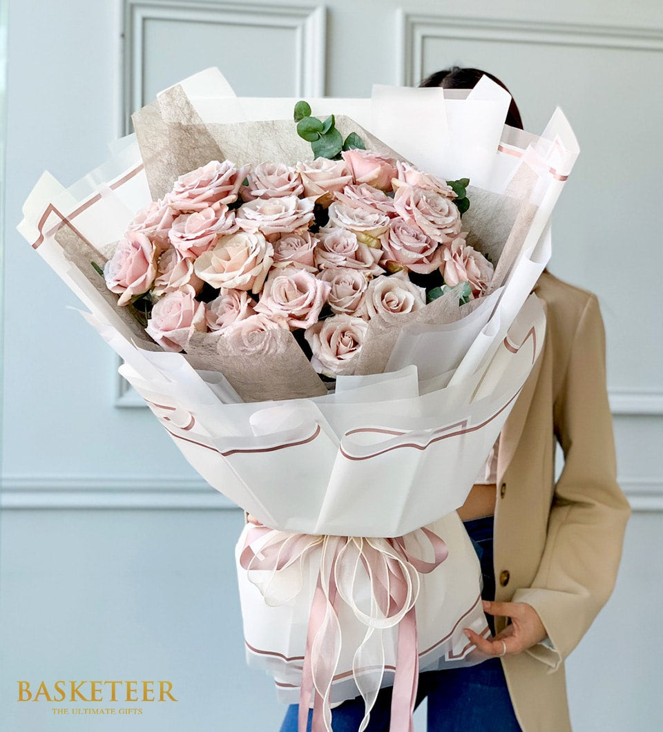 Blush pink rose bouquet with eucalyptus and pink ribbon for anniversaries and romantic occasions