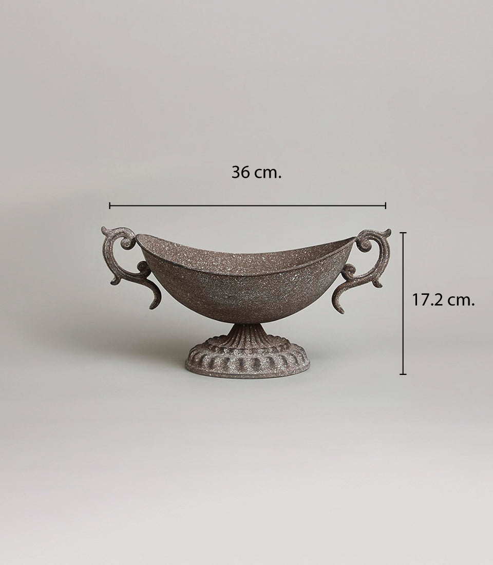 Ornate rustic metal urn vase with scrolled handles and speckled bronze finish, pedestal base