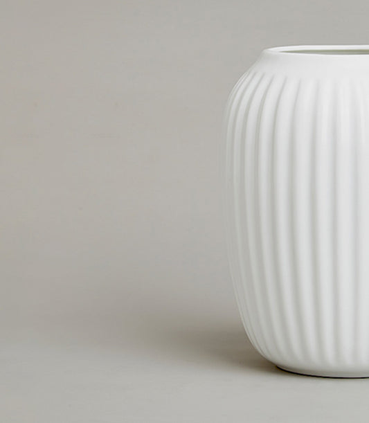 Minimalist white ceramic vase with ribbed fluted texture and matte finish