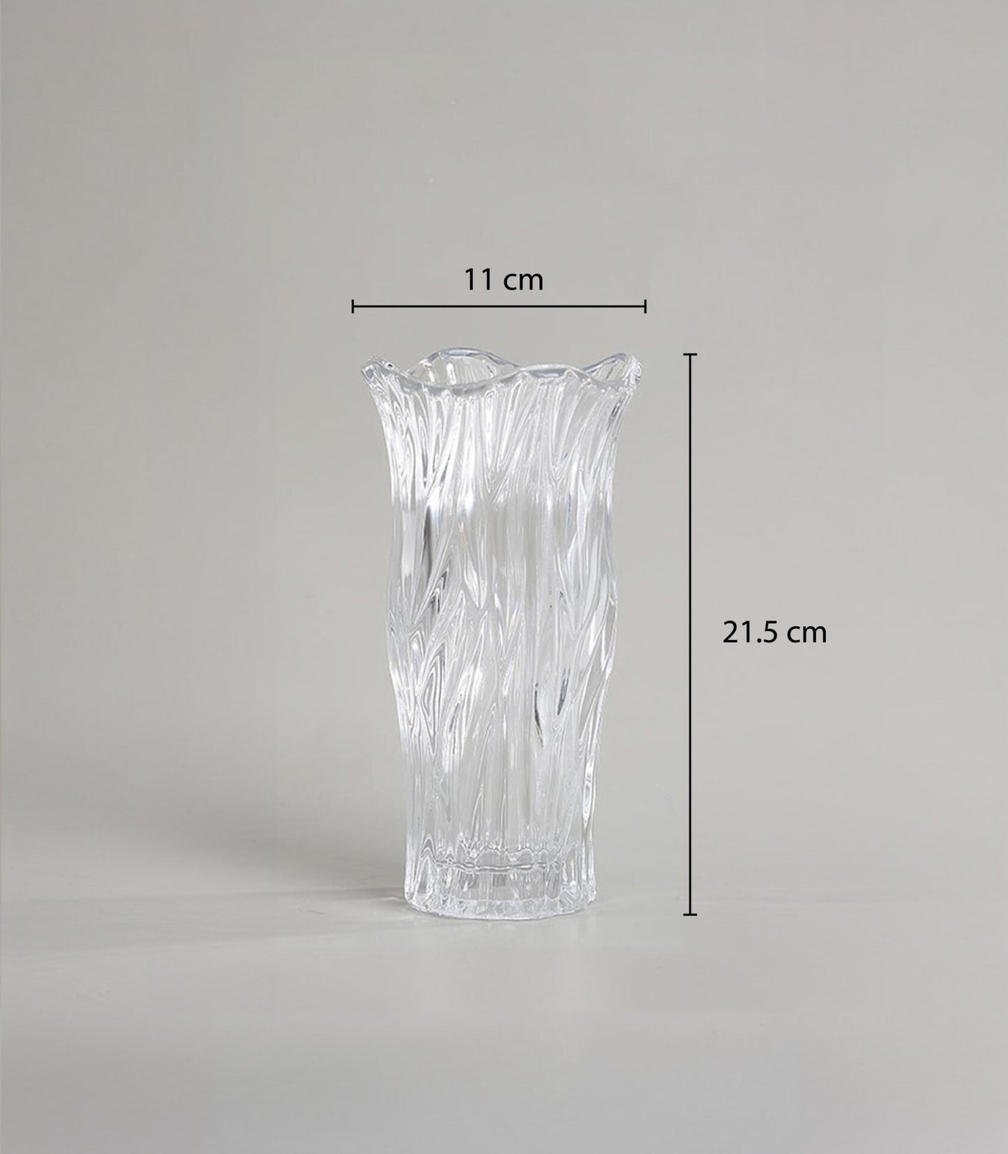 Clear glass vase with textured wave design and scalloped rim for fresh flowers or decorative display