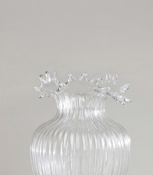 Clear glass vase with ribbed texture and ruffled splash rim