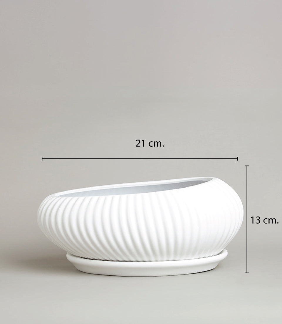 White ceramic ribbed vase with wavy texture and matching saucer, 21cm length