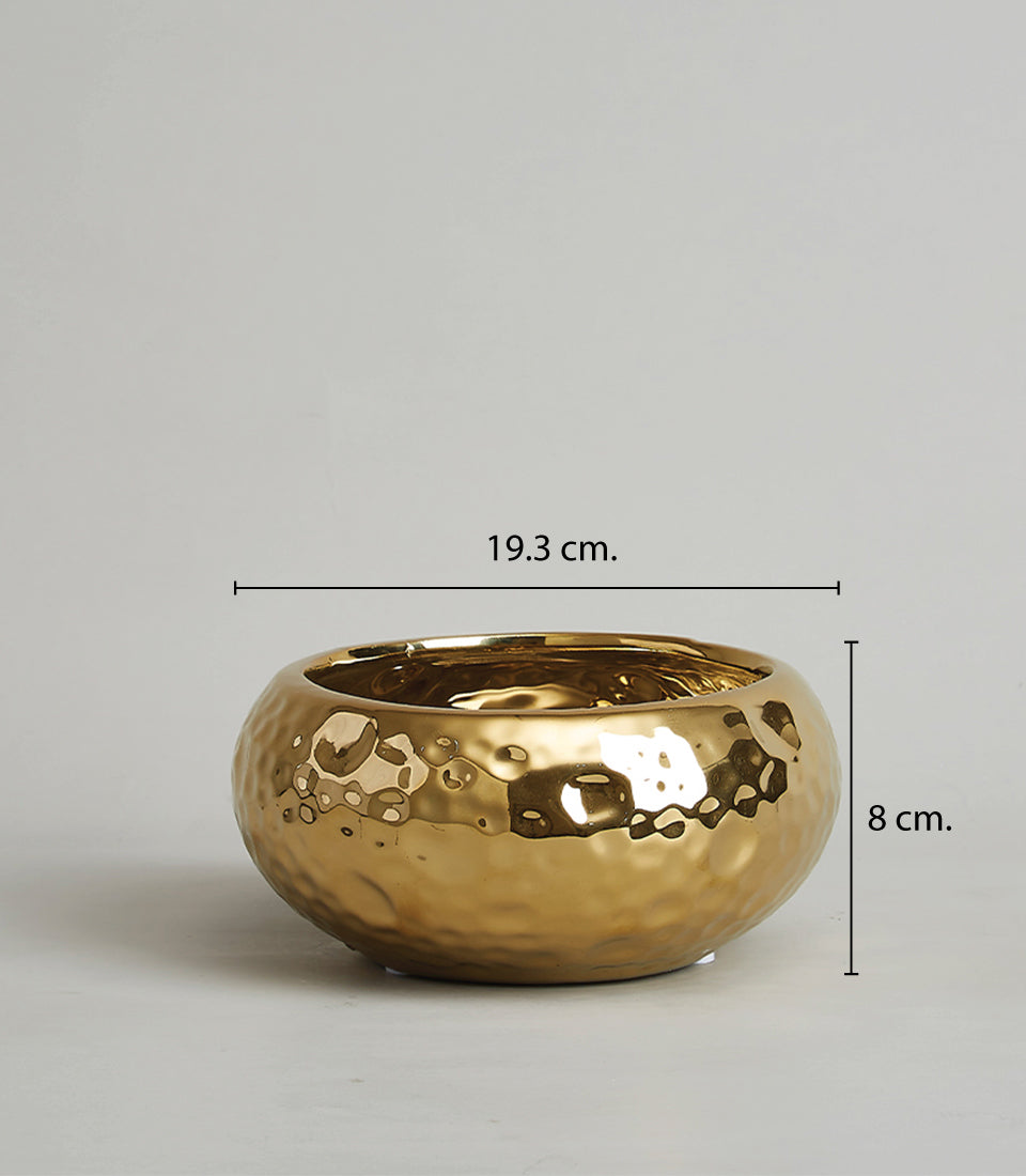 Gold hammered ceramic bowl with reflective metallic finish, perfect for luxury gifting