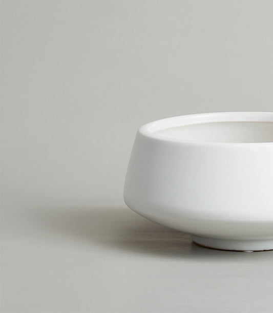 White ceramic bowl-shaped vase with glossy finish and tapered body, perfect for fresh flowers or home décor gifting