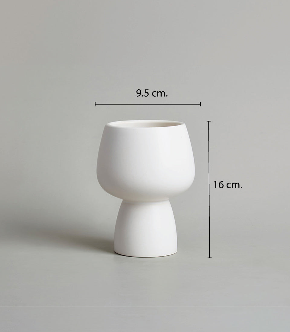 Modern white ceramic chalice vase with matte finish and tapered goblet silhouette