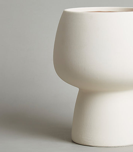Cream ceramic chalice vase with modern sculptural silhouette and textured matte finish