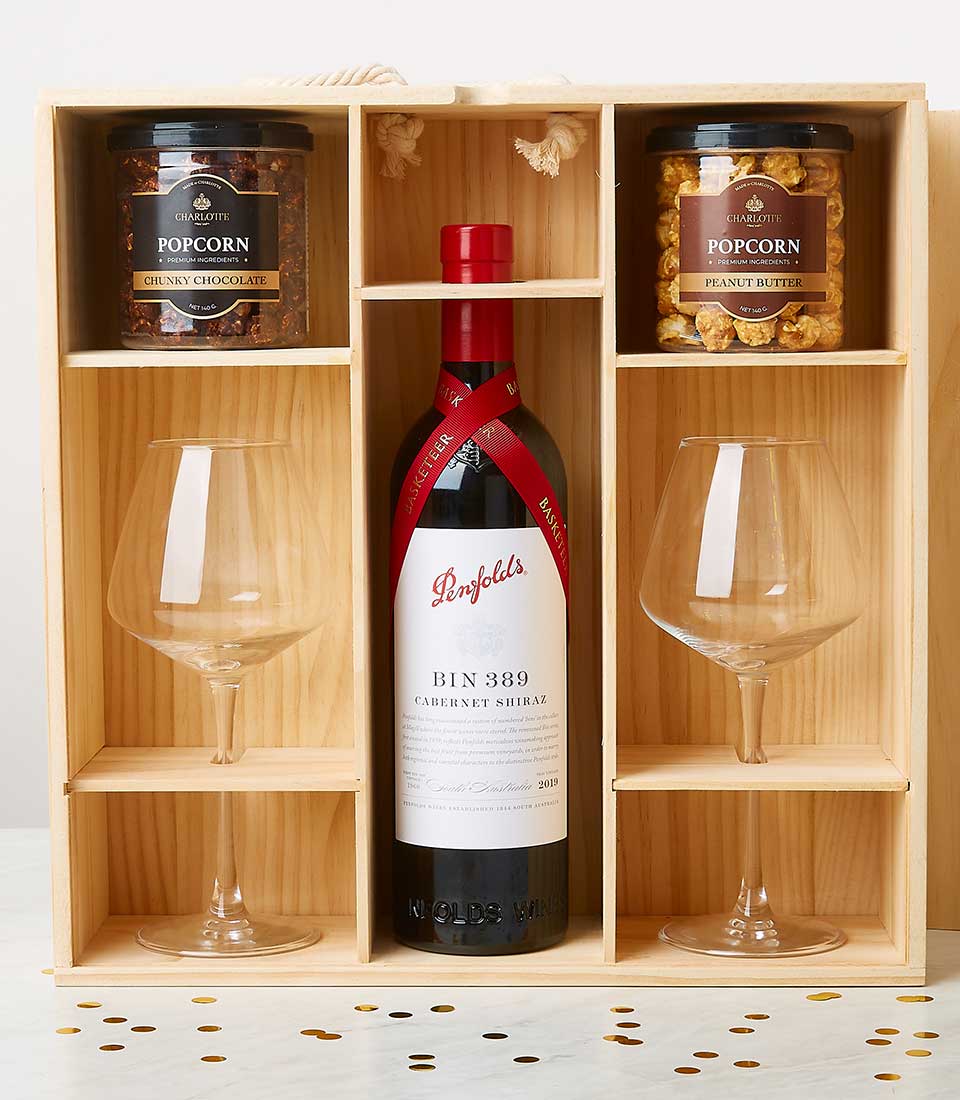 Wooden luxury gift box with Penfolds wine, stemmed glasses, and gourmet popcorn selections
