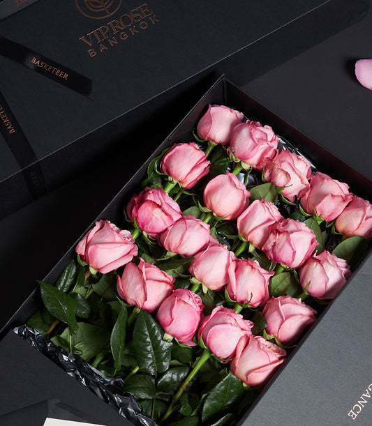 Luxury pink roses in black gift box with gold foil logo, perfect for Valentine's Day