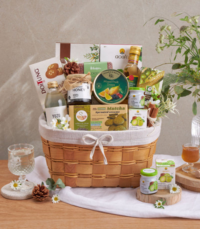 Premium wellness gift basket with organic superfoods, yuzu drink, raw honey, matcha cookies, and coconut oil