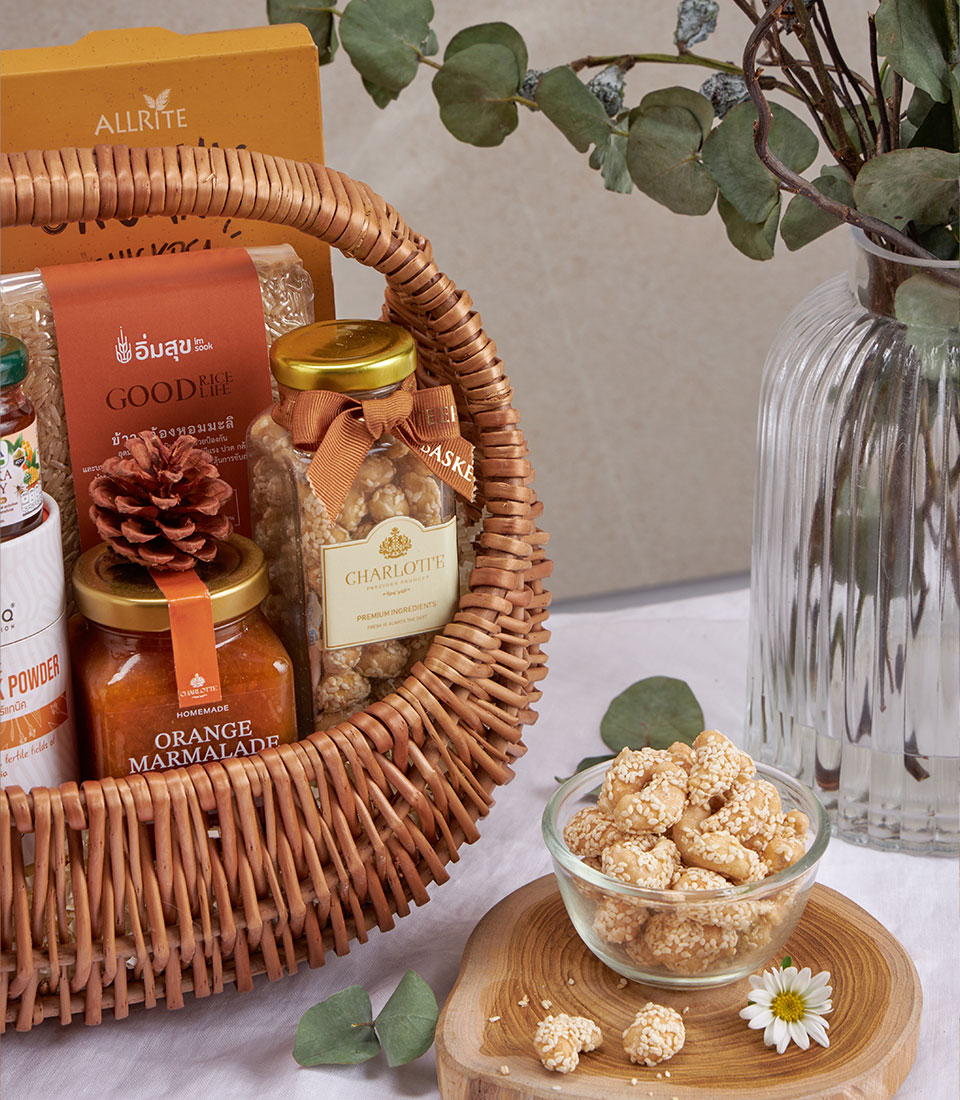 Premium wellness gift basket with artisan marmalade, sesame snacks, and organic rice in woven wicker