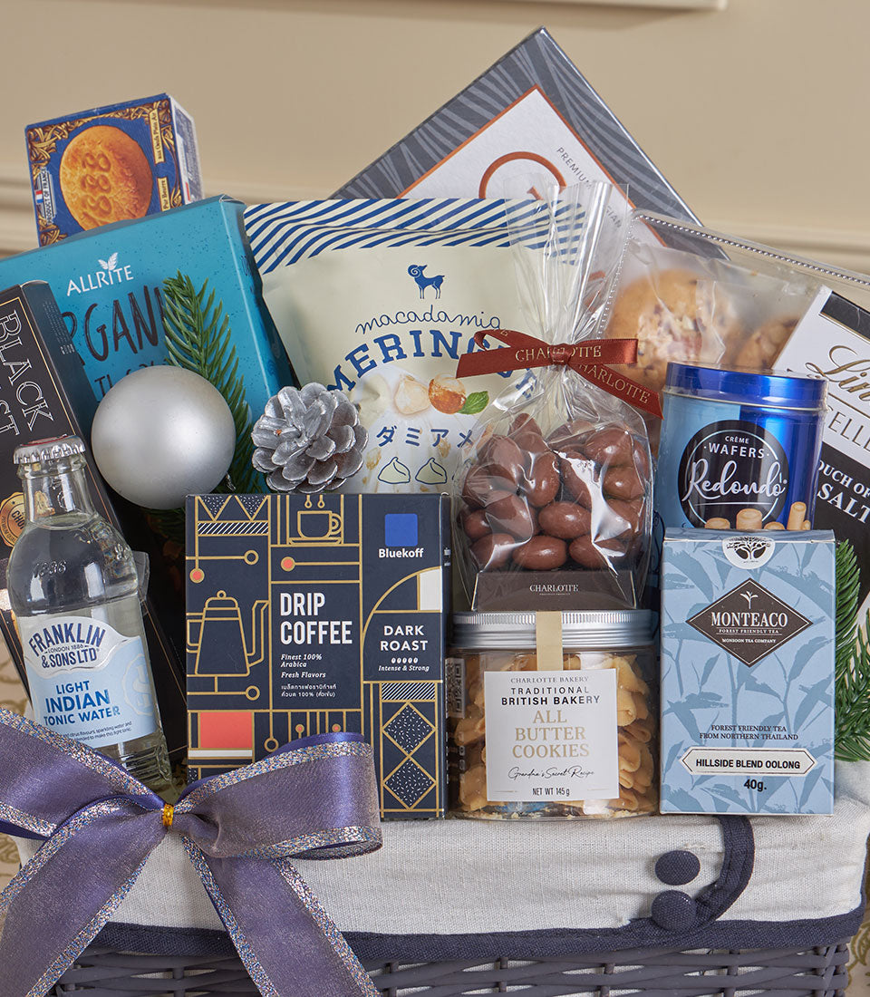 Blue luxury gourmet gift basket with premium coffee, macadamia nuts, cookies, tea and tonic water for New Year gifting
