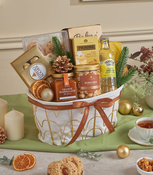 Premium almond and citrus gourmet gift basket with chocolates, tea, marmalade, and festive gold accents for New Year gifting