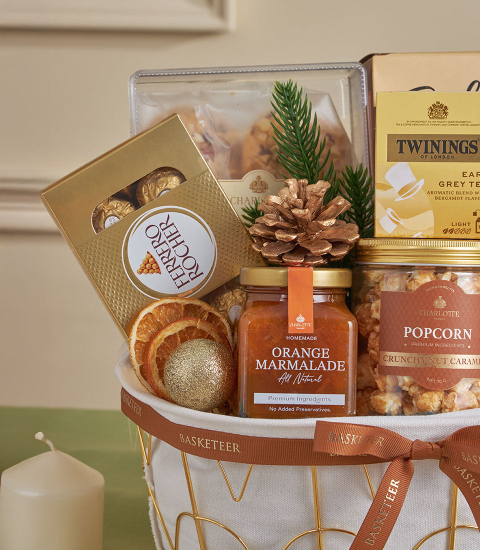 Premium almond and citrus gourmet gift basket with chocolates, tea, and marmalade for New Year gifting
