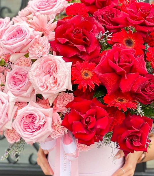 Pink and red roses with gerbera daisies in luxury gift box for birthday celebrations