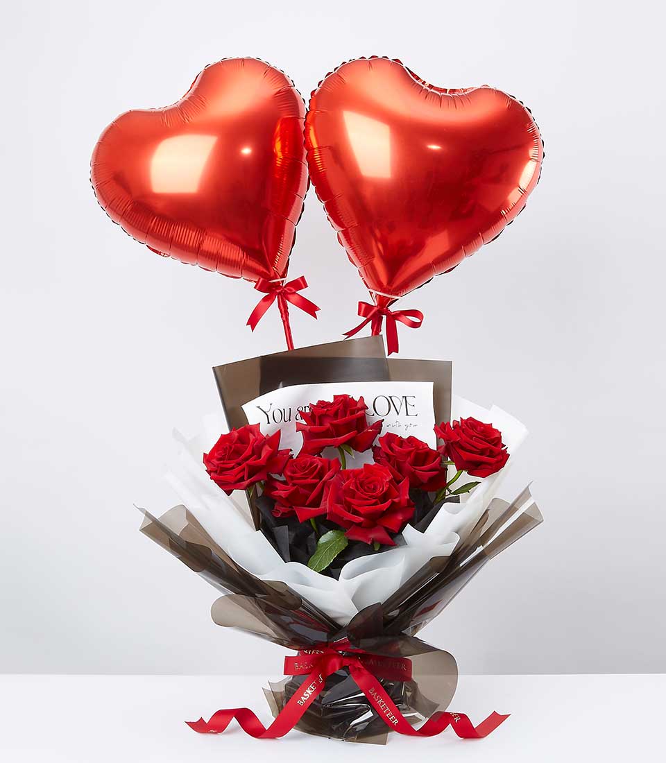 Red roses with heart balloons romantic gift bouquet, wrapped in kraft paper with love greeting card