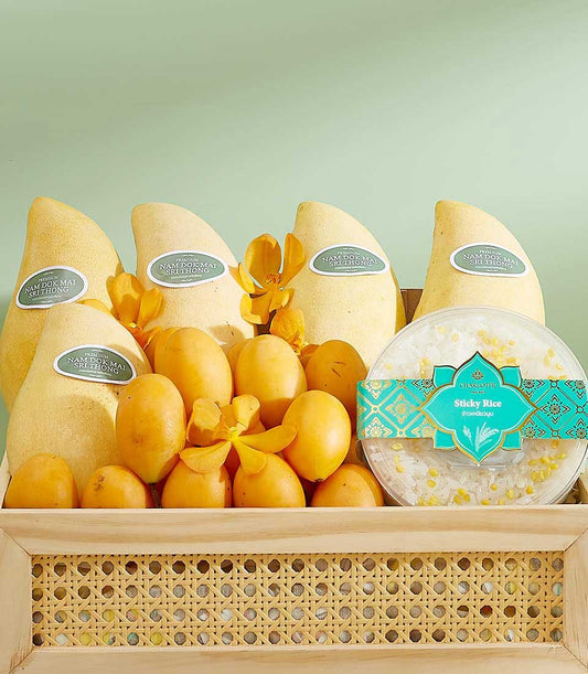 Luxury gift basket with Nam Dok Mai mangoes, tropical fruits, yellow orchids, and sticky rice dessert