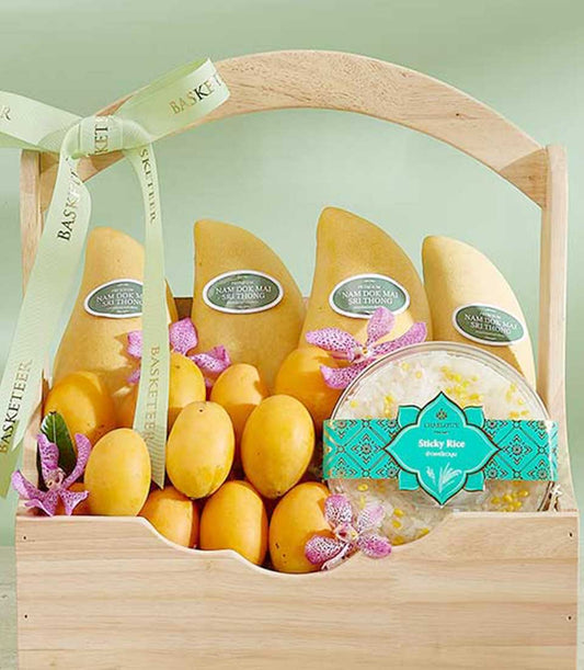 Wooden gift basket with Nam Doc Mai mangoes, sticky rice, and purple orchids