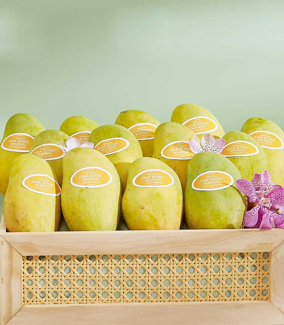 Premium Thai Oak Rong mangoes in handcrafted wooden gift box with fresh orchids