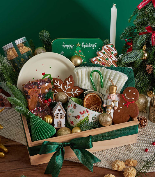 Festive Christmas gift basket with Charlotte shortbread, fruitcake, gingerbread cookies, ceramic plate, and holiday