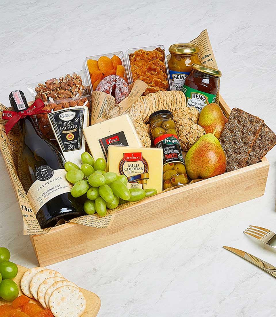 Premium gourmet hamper with red wine, artisan cheeses, cured meats, and gourmet preserves in wooden crate