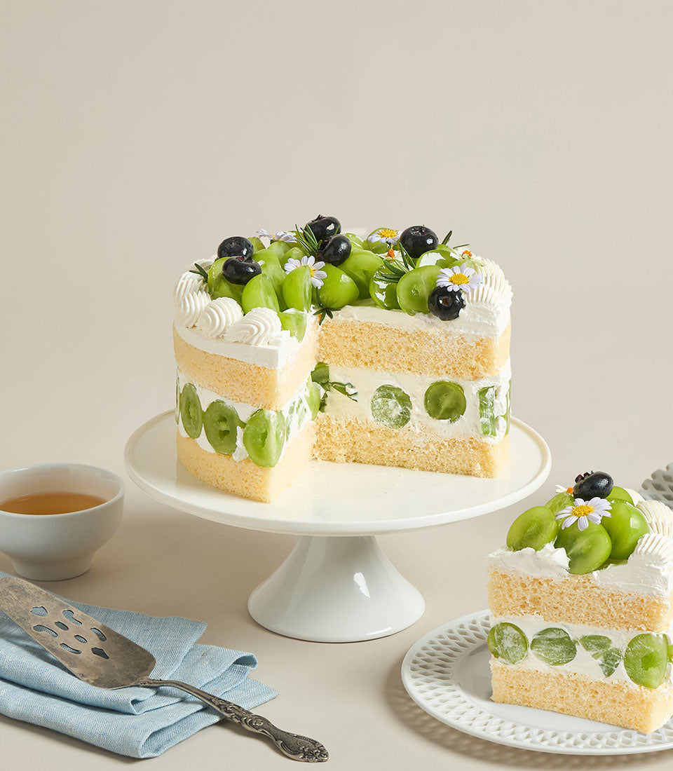 Charlotte Bakery's artisan vanilla cream cake with layers of sponge, fresh Shine Muscat