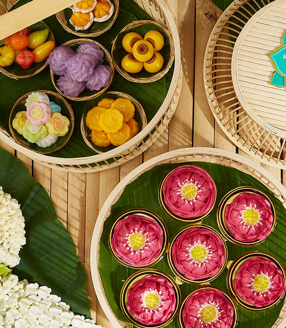 Traditional Thai Kanom Ar-Lua sweets collection in bamboo baskets and lotus-shaped desserts, perfect for Songkran celebration