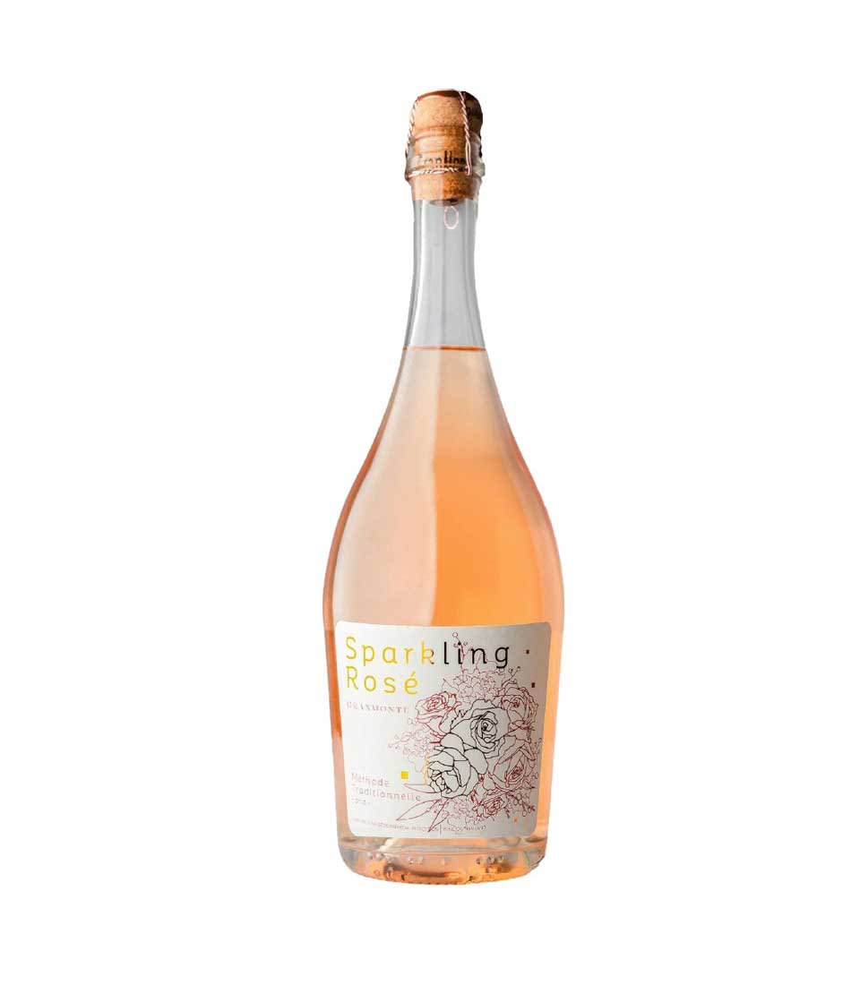 Sparkling rosé Méthode Traditionnelle brut wine bottle with rose illustrations on label