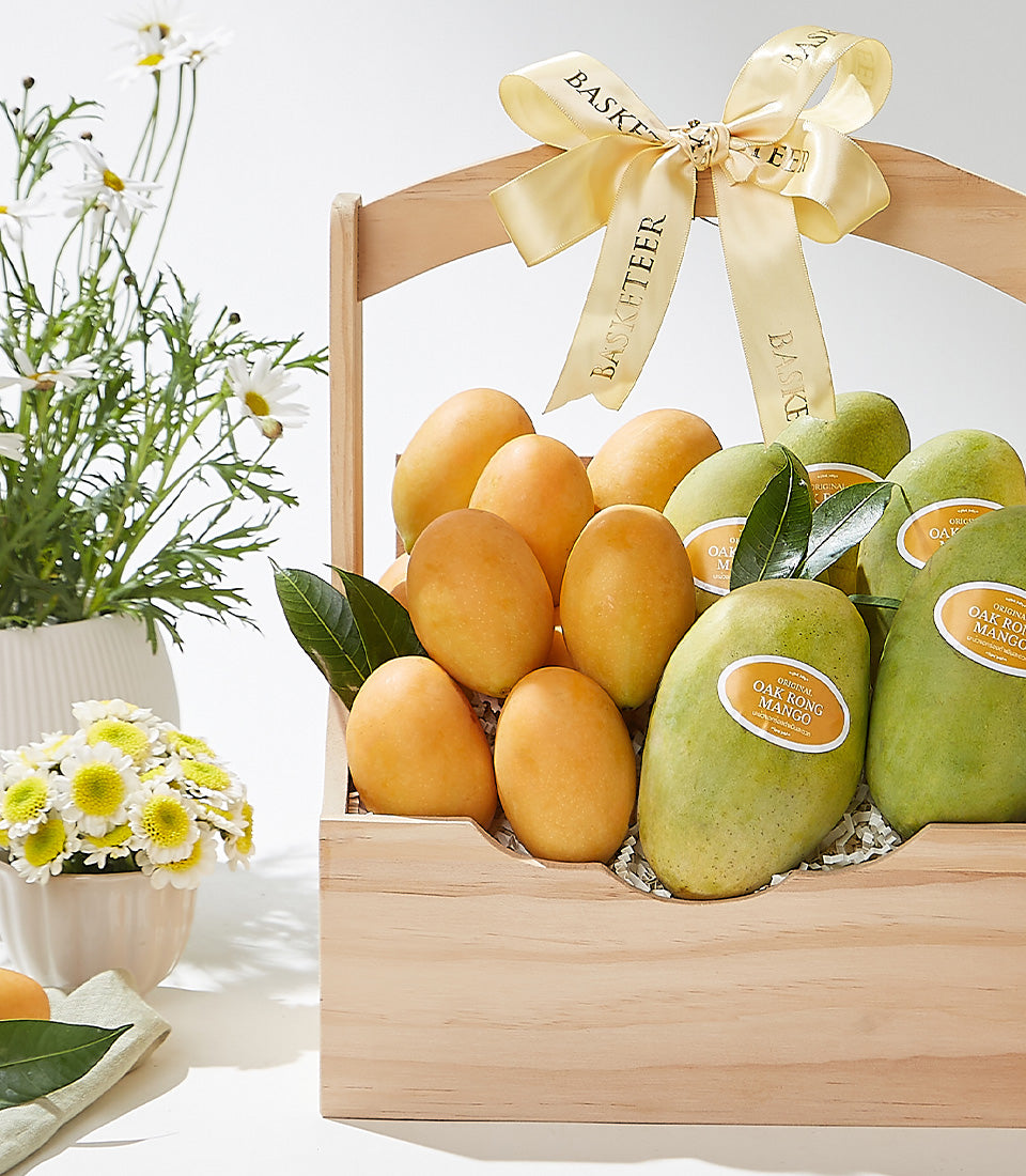 Wooden gift basket with Thai mangoes, white daisies, and gold ribbon bow