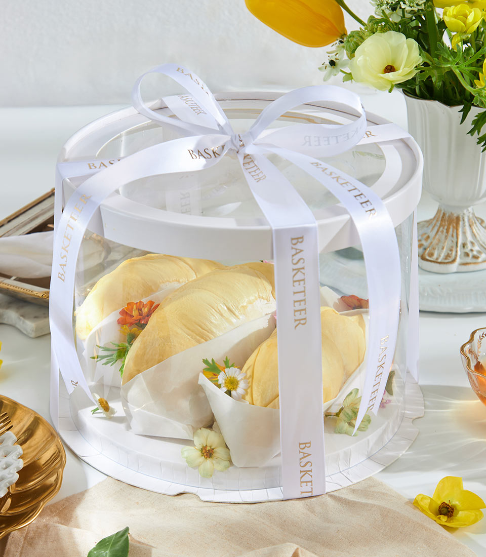 Premium Rayong Mon Thong durian gift box with white ribbon and gold Basketeer branding, individually wrapped portions on