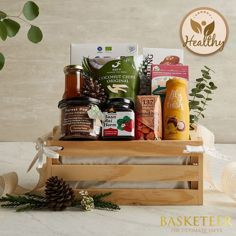 Light wood crate gift basket with organic riceberry, strawberry jam, honey, almond milk, coconut chips, and fresh juice