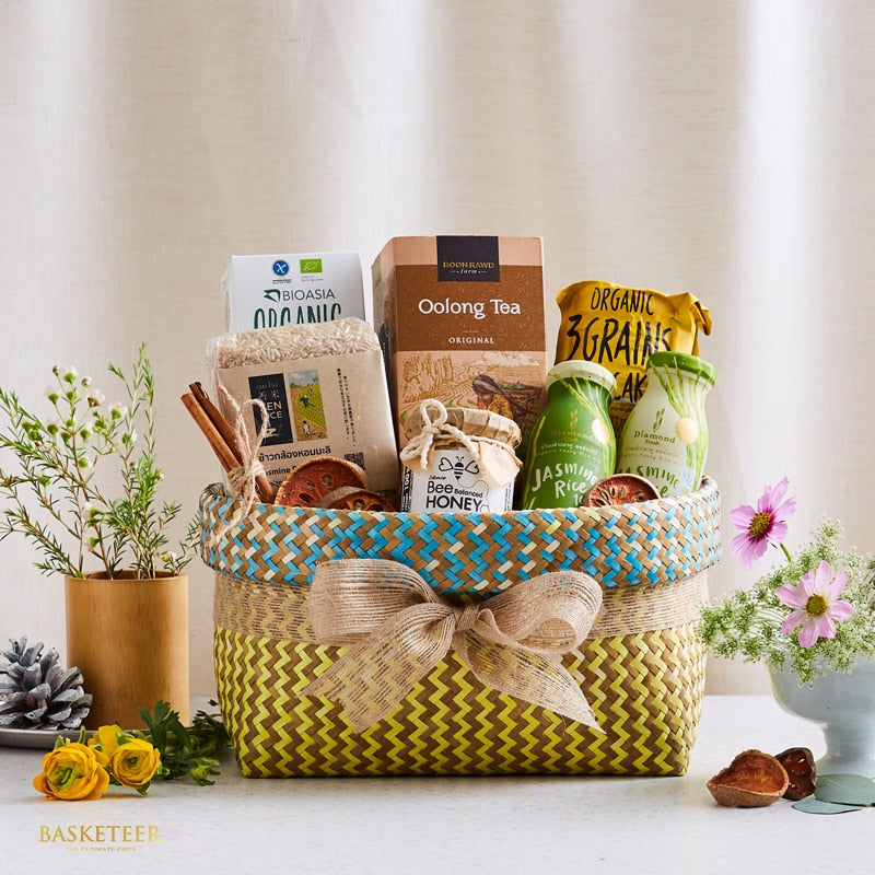 Woven gift basket with organic tea, honey, rice, and wellness foods for health-conscious gifting